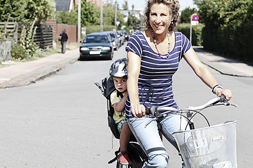 woman-and-toddler-bike-riding-on-a-street-living-life-with-a-stoma